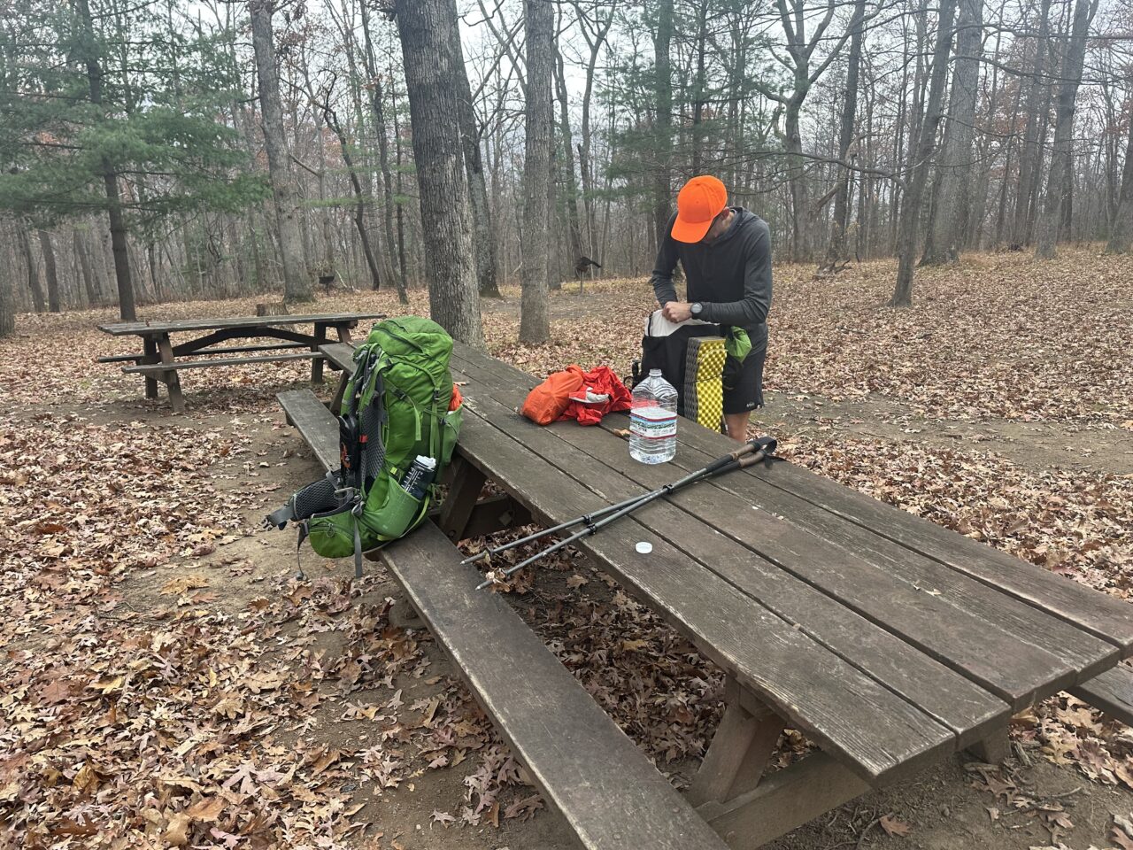 man eating at picnic table at campground